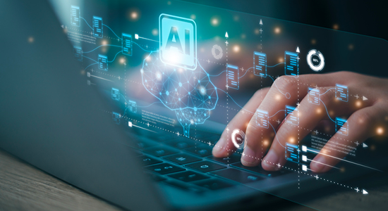 Close-up of hands typing on a laptop keyboard with a glowing digital overlay of an AI brain icon, data connections, charts, and interface elements hovering above the screen.