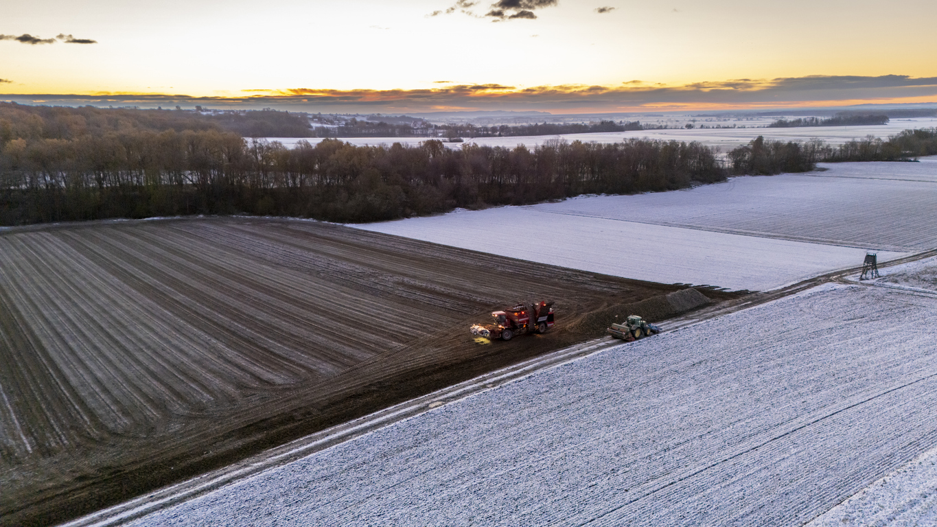 A tractor in a snowy field.