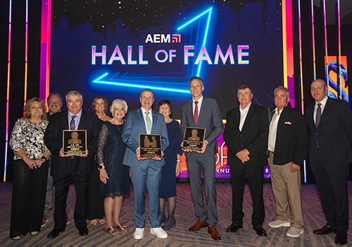 2025 Hall of Fame representatives gather on a stage at the 2025 AEM Annual Conference. 